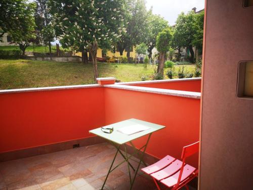 a small white table and two chairs on a balcony at ALBERGO BALDAZZI 1916 in Zavattarello
