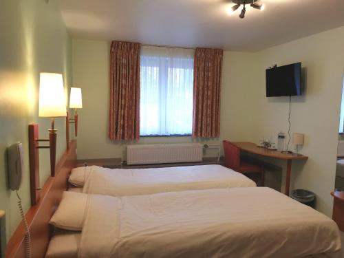 Postel nebo postele na pokoji v ubytování Hotel Aux Beaux Rivages En Gaume