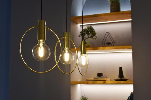 a group of light bulbs hanging from a ceiling at Vibrant Apartment in Tirana