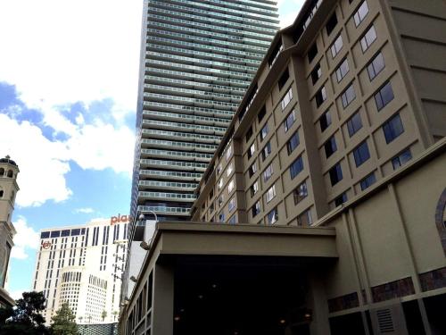 a tall building in front of a building at Jockey Resort Suites Center Strip in Las Vegas