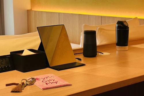 a wooden desk with a bunch of items on it at Kyoto ITOYA Hotel Mon in Kyoto