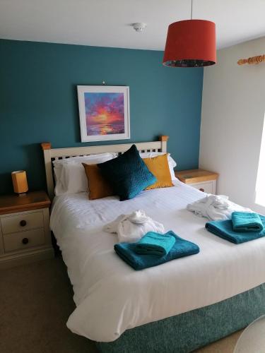 a bedroom with a bed with towels on it at The Prince of Wales in Helston