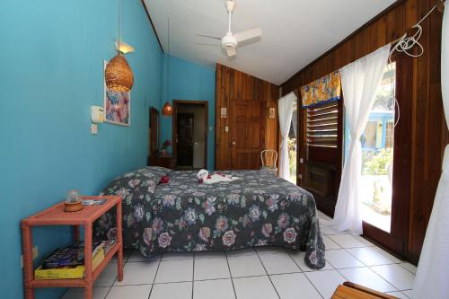 a bedroom with a bed with a cat laying on it at Xtabi Resort in Negril