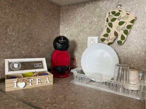 a counter top with a bottle of water and a plate at Burgas Residence 712 in Burgas