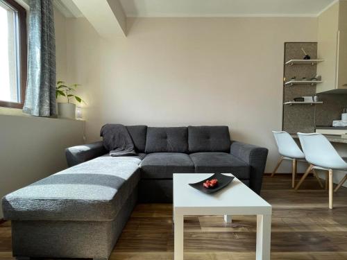 a living room with a couch and a table at Burgas Residence 712 in Burgas