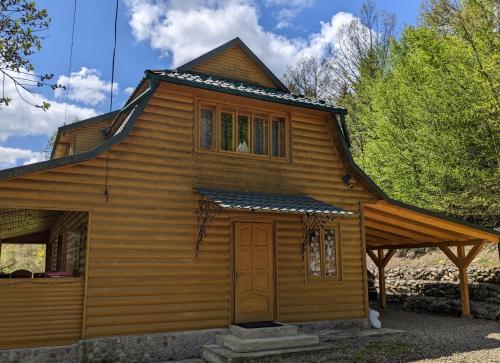 a wooden house with a door and a window at Sheshory Chalet in Sheshory