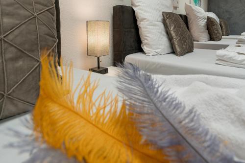 a bedroom with two beds withumedumed feathers on them at Cannstatter Hotel in Stuttgart