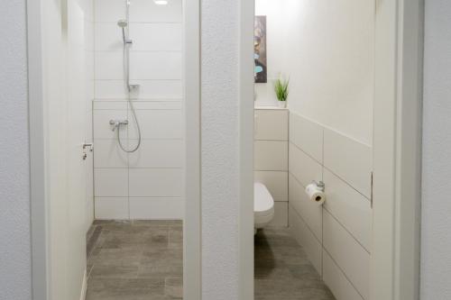 a bathroom with a shower and a toilet at Cannstatter Hotel in Stuttgart