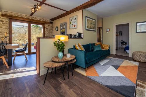 un salon avec un canapé bleu et une table dans l'établissement Gîte du Pacha, à Coussac-Bonneval
