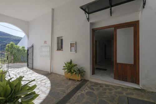 a entrance to a building with a wooden door at Rincon de los Deseos in Benamahoma