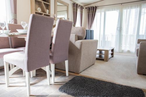 a living room with a dining table and chairs at Mersea Island by Away Resorts in Colchester
