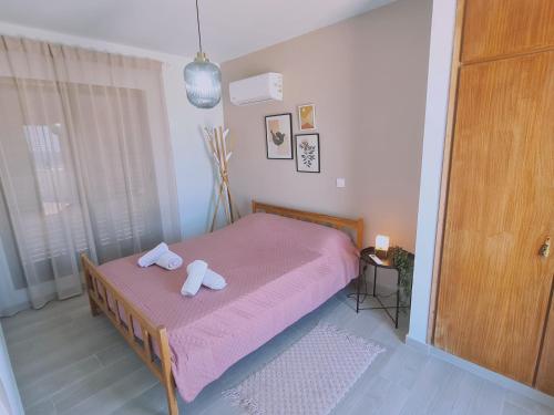 a bedroom with a bed with two towels on it at STAY BelleVue Apartment in Khlorakas