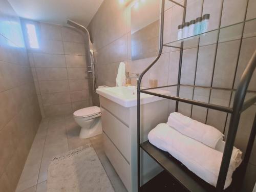 a small bathroom with a toilet and a sink at STAY BelleVue Apartment in Khlorakas