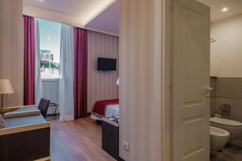 a hotel room with a bed and a bathroom at Hotel Nazionale in Rome