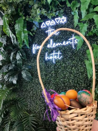 a basket of eggs in front of a sign at The Five Elements Hotel and SPA in Sapareva Banya