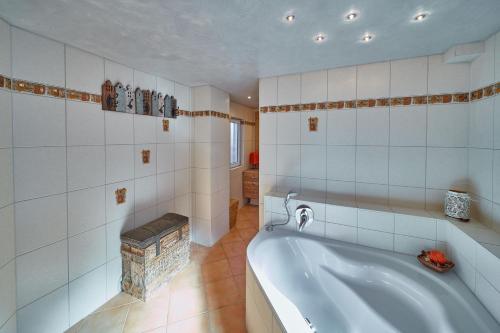 a bathroom with a bath tub in a room at Herzo Center Apartments in Herzogenaurach