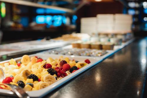 a buffet line with plates of food on a counter at Van der Valk Hotel Saint-Aygulf in Saint-Aygulf