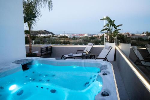 a hot tub on the roof of a building at JnS Faliraki Penthouse in Kallithea Rhodes