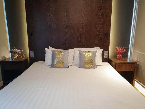 a bedroom with a large bed with white sheets and pillows at Geo 38 Residence Genting Highland in Genting Highlands