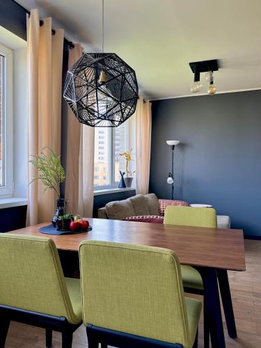 a dining room with a wooden table and chairs at Cosy place in small town in Maardu