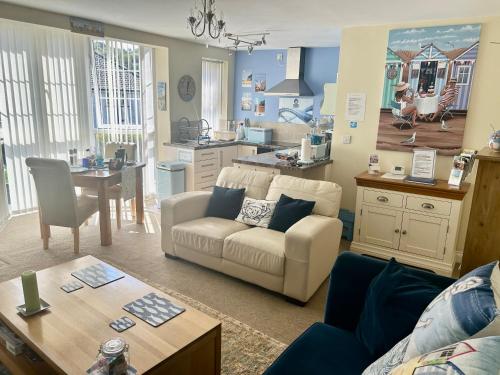 a living room with a couch and a kitchen at BAKERY CENTRAL in Cromer