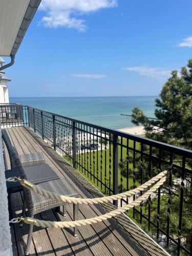 a balcony with a view of the beach at meergut HOTELS in Kühlungsborn