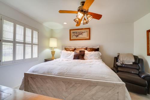 a bedroom with a large bed with a ceiling fan at Lovely Phoenix Vacation Rental Home with Pool! in Phoenix