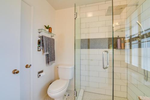 a bathroom with a toilet and a glass shower at Lovely Phoenix Vacation Rental Home with Pool! in Phoenix
