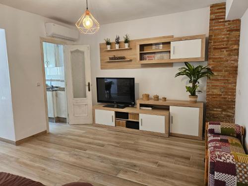 a living room with a flat screen tv on a wall at "Corner of happiness" in Cullera