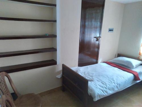 Ένα ή περισσότερα κρεβάτια σε δωμάτιο στο Homely Homestay