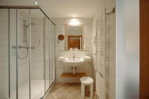 a bathroom with a sink and a shower at Hotel Waldfrieden in Schladming