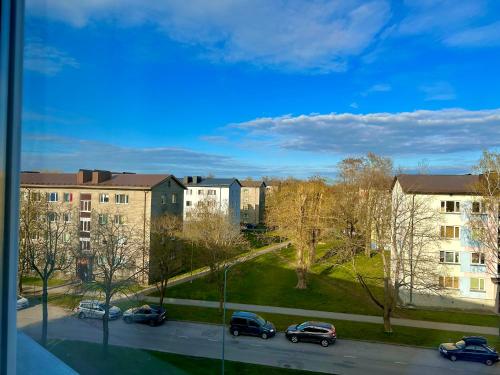 a view of a parking lot with buildings and cars at Cosy place in small town in Maardu