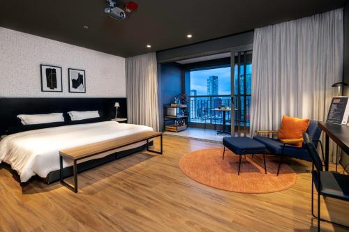 a bedroom with a bed and a view of a city at Intercity Tatuapé in Sao Paulo