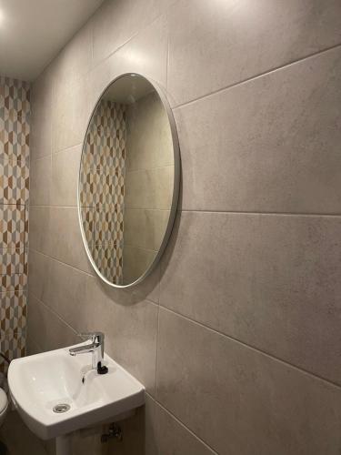 a bathroom with a sink and a mirror at Skyline Apartments in Rīga