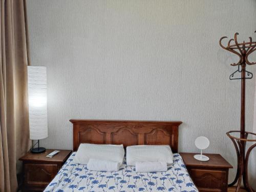 a bedroom with a bed with two pillows on it at Friendly Guest House in Kutaisi