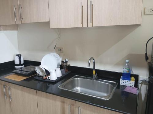 a kitchen with a sink and a counter top at Breeze Residences - 1BR Unit with Balcony -Top Floor in Manila