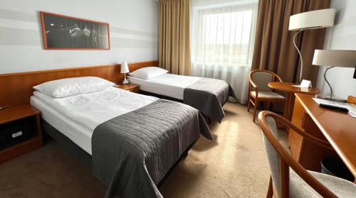 Postel nebo postele na pokoji v ubytování City Hotel