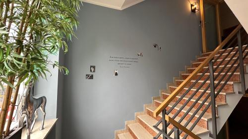 a staircase in a building with a sign on the wall at Alpenstadthotels in Bad Reichenhall