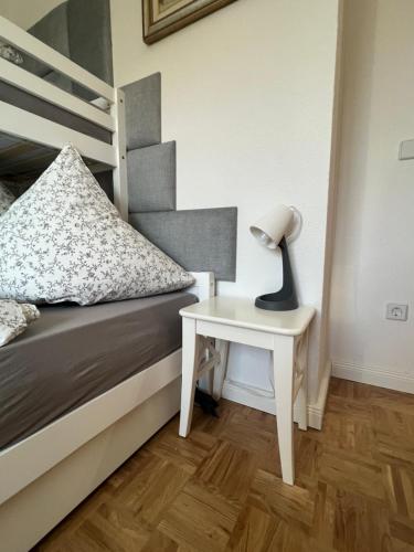 a bedroom with a bed and a table with a lamp at Sweet Home cozy Dresden Apartment three in Dresden