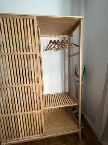 a wooden closet with wooden hangers in a room at Sweet Home cozy Dresden Apartment three in Dresden