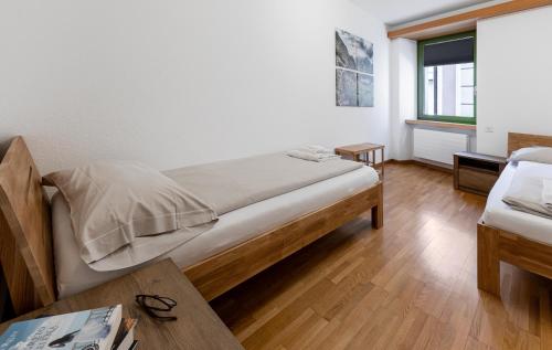 a bedroom with a bed and a table and a window at Casa Bernina in Poschiavo
