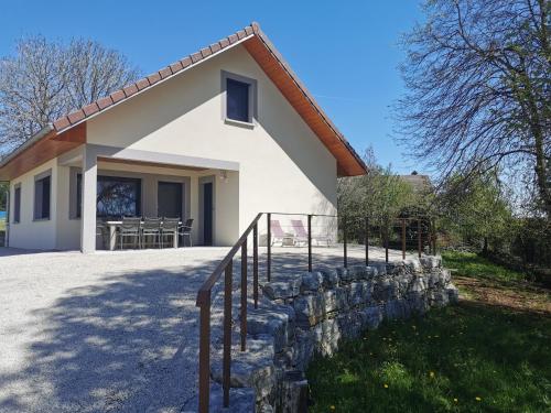 a small white house with a stone wall at La Maison du Colombier in Le Fied