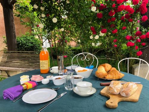 a blue table with food and bread on it at Chateau de Vaugelas - Charmant domaine près de Valence in Alixan
