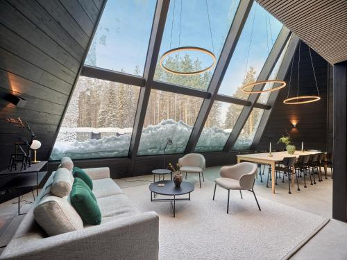 a living room with a couch and a large window at Glass Resort in Rovaniemi