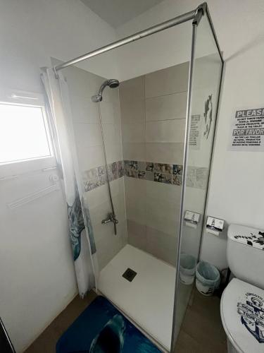 a shower with a glass door in a bathroom at Casa Rosaura in La Santa