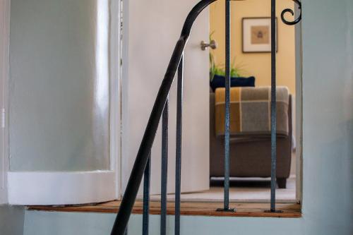 a hallway with a mirror and a chair in a room at Drury's in Corfe Castle