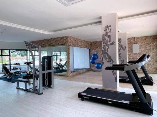 a gym with a treadmill and treadles in a room at Mutiara Melaka Beach Resort by Minso in Tangga Batu