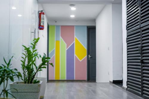 a hallway with a colorful mural on the wall at Saltstayz Express - Golf Course Road & DLF Phase-1 in Gurgaon