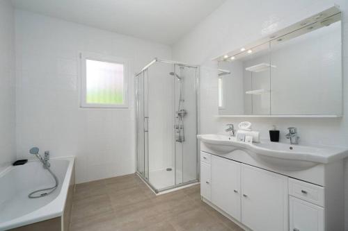 a white bathroom with a sink and a shower at Seyssuel • Villa Paisible • HostisY in Seyssuel