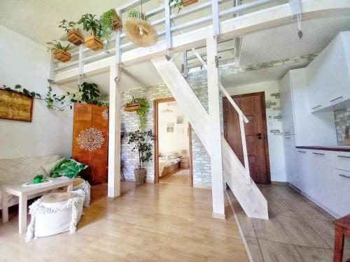 a living room with a staircase in the ceiling at Eleonor Accommodation in Liszki